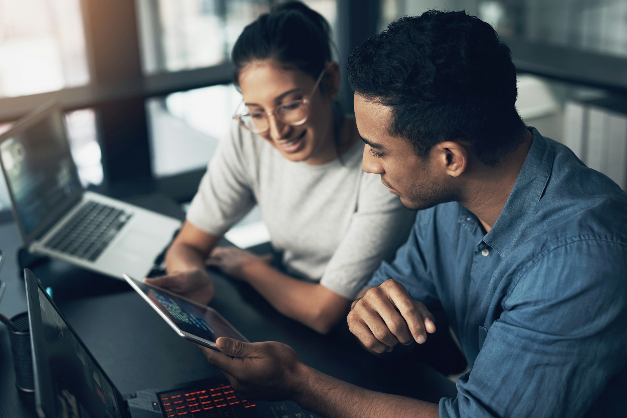 shot of two young workers using a digital tablet in a modern office.jpg